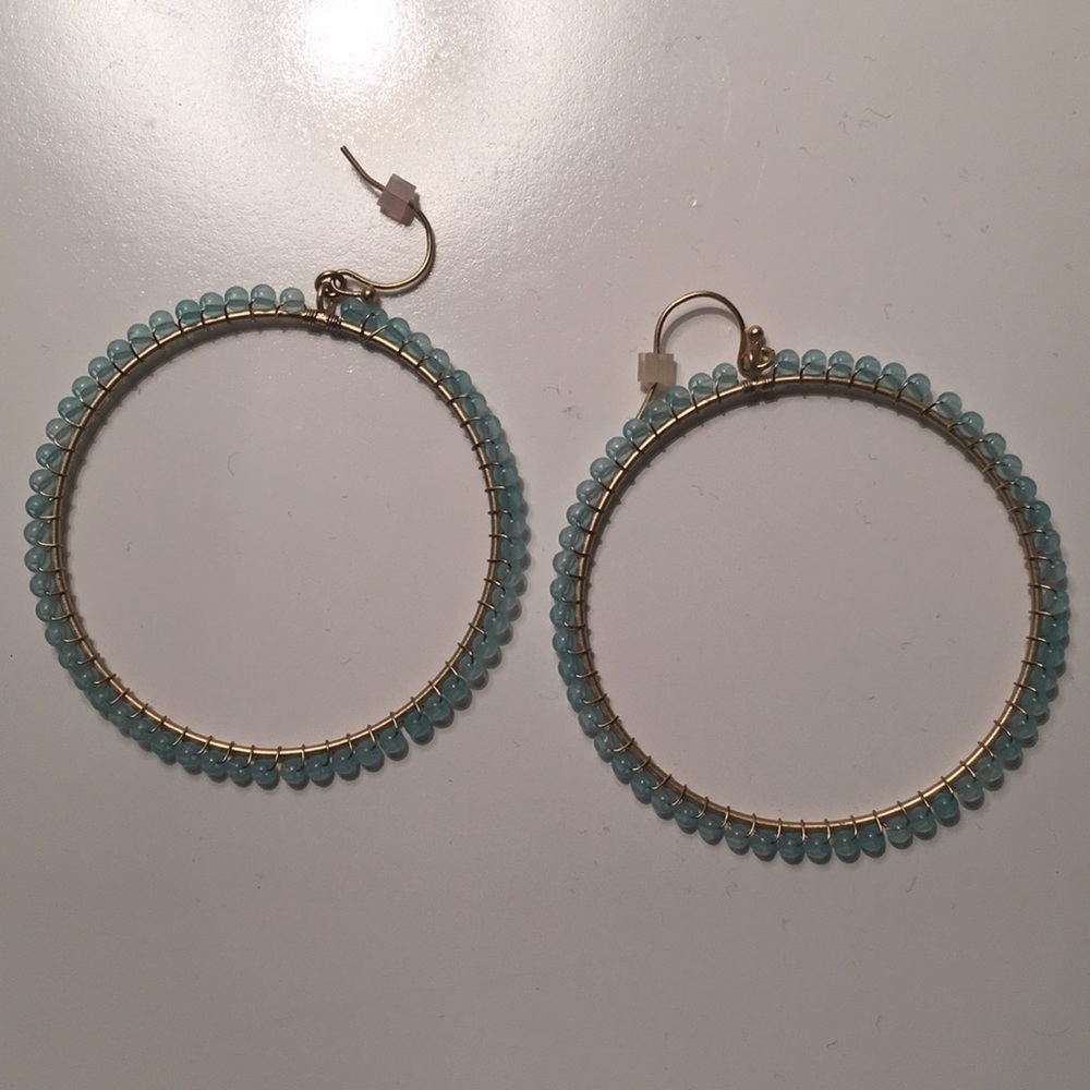 Gold hoop earring with light blue beads